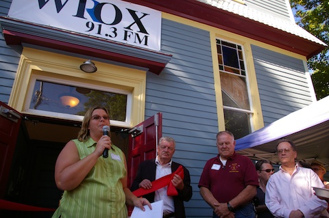 WIOX operations manager Jennifer Schuman welcomes the crowd while managing consultant Joe Piasek, far right, looks on.